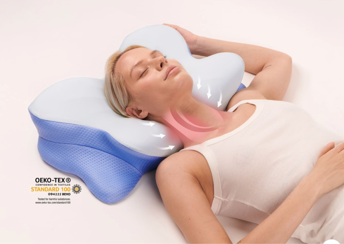 Woman asleep on a butterfly-contoured memory foam pillow, arms resting in the side cut-outs